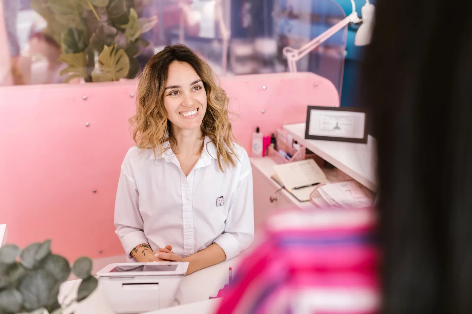 Receptionist welcoming a guest at a front desk